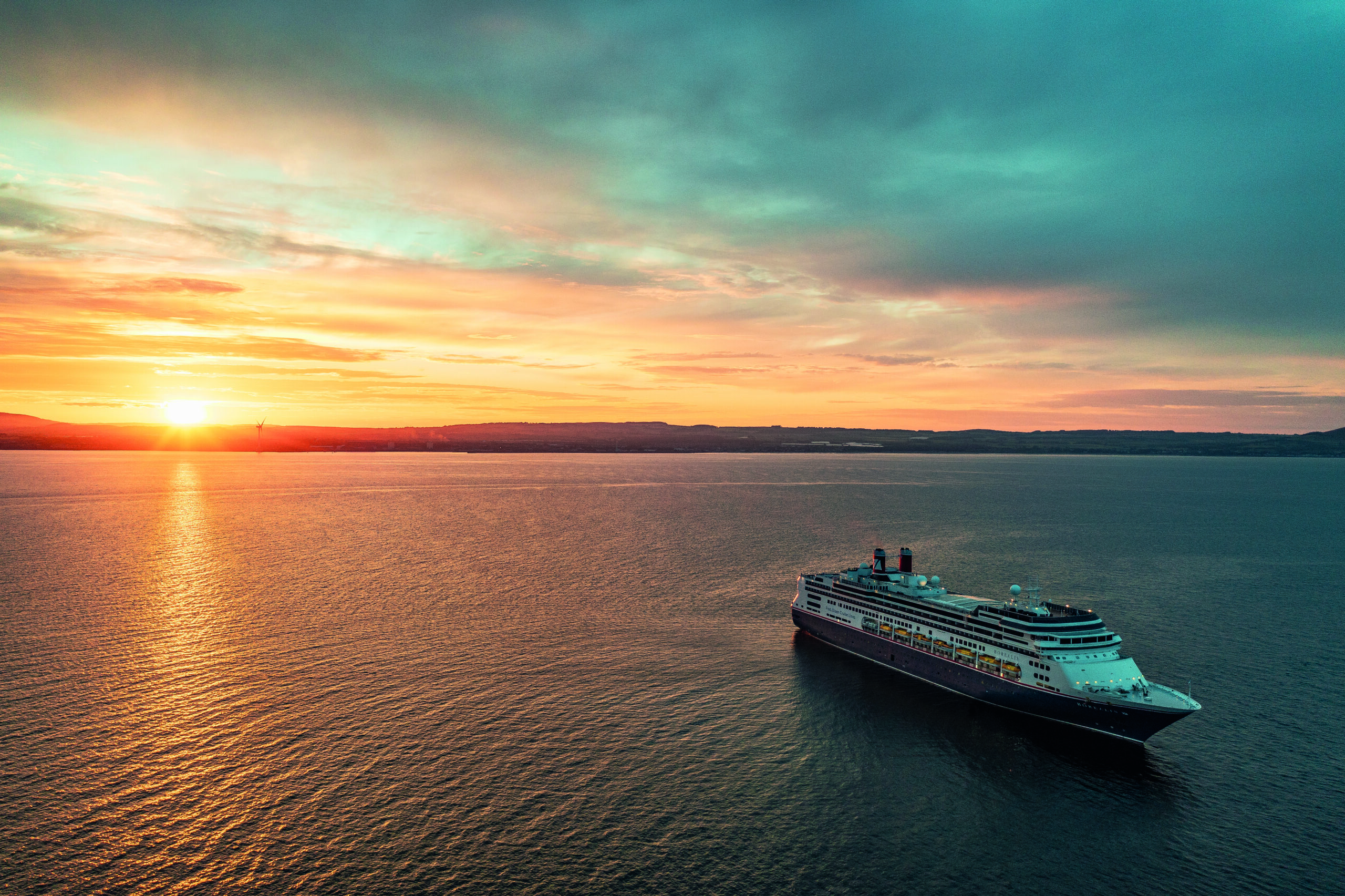 Borealis at sea at sunset