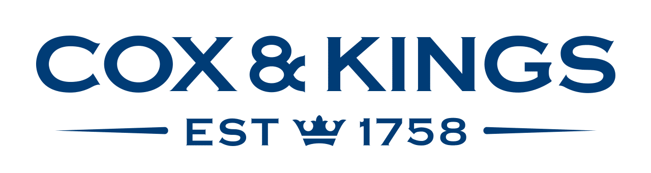 Cox & Kings logo in blue with the text 'EST 1758' and a crown icon between EST and 1758.